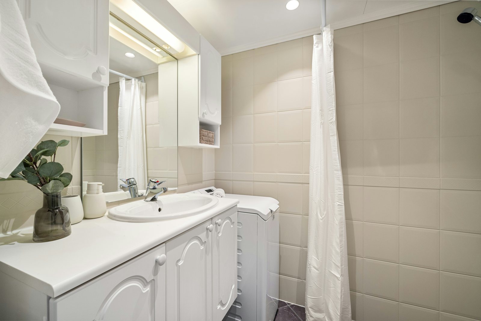 Bathroom basin, faucet and shower enclosure; representative moisture-prone room, not a Houston job