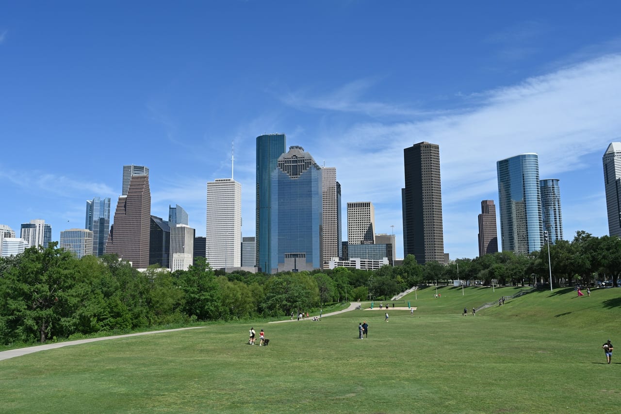 Downtown Houston skyline viewed across a green park; regional orientation, not an example job